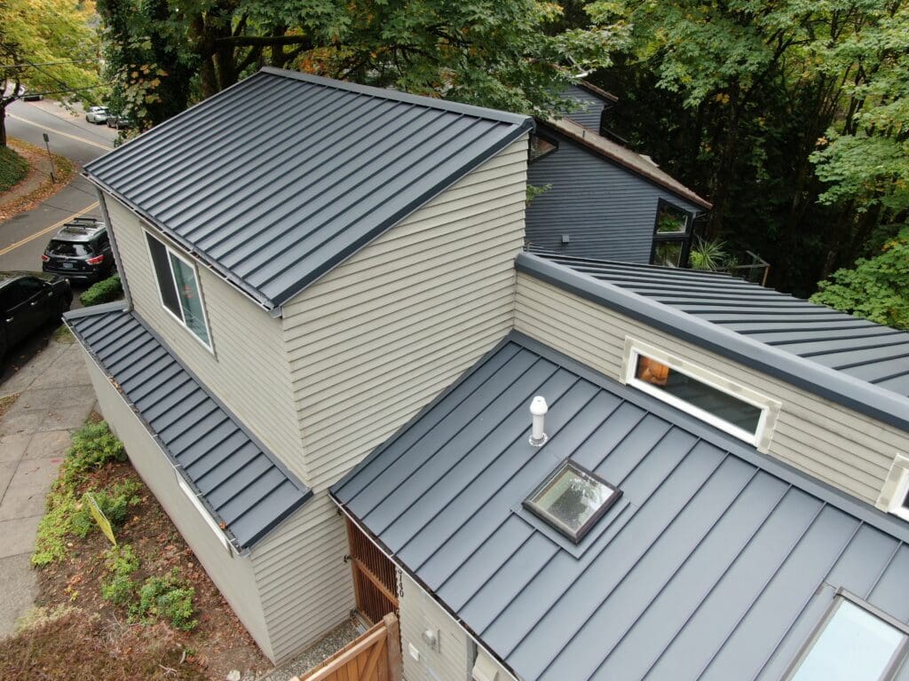 Charcoal gray standing seam metal roof with skylights