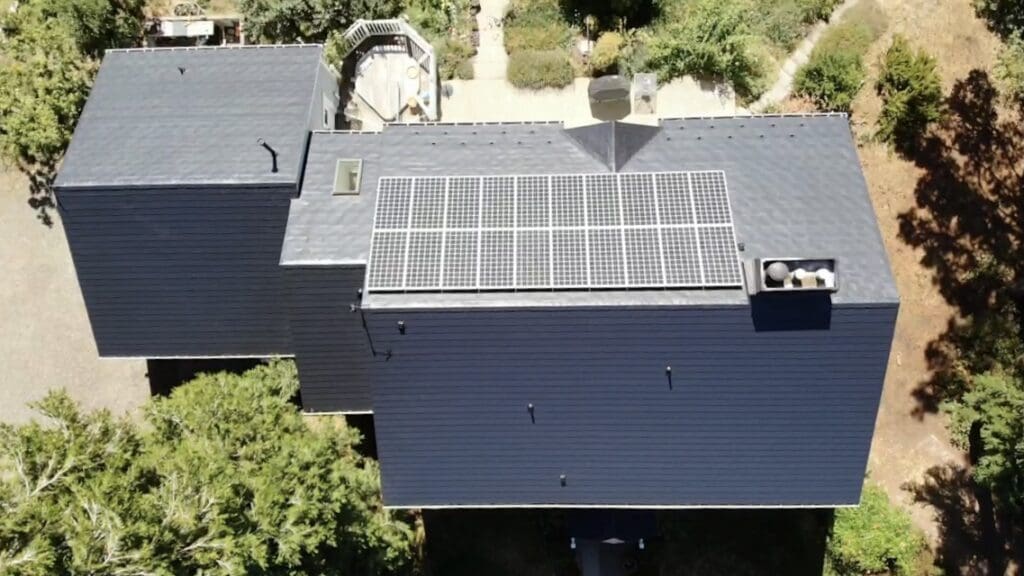 Picture taken from directly above a home with metal roofing and solar panels to help illustrate Tax Credits for Metal Roofing