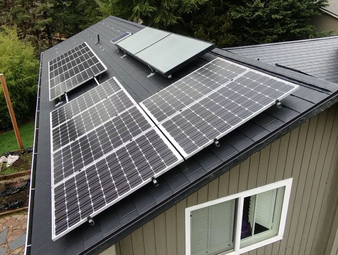 Solar panels on a charcoal black standing seam metal roof
