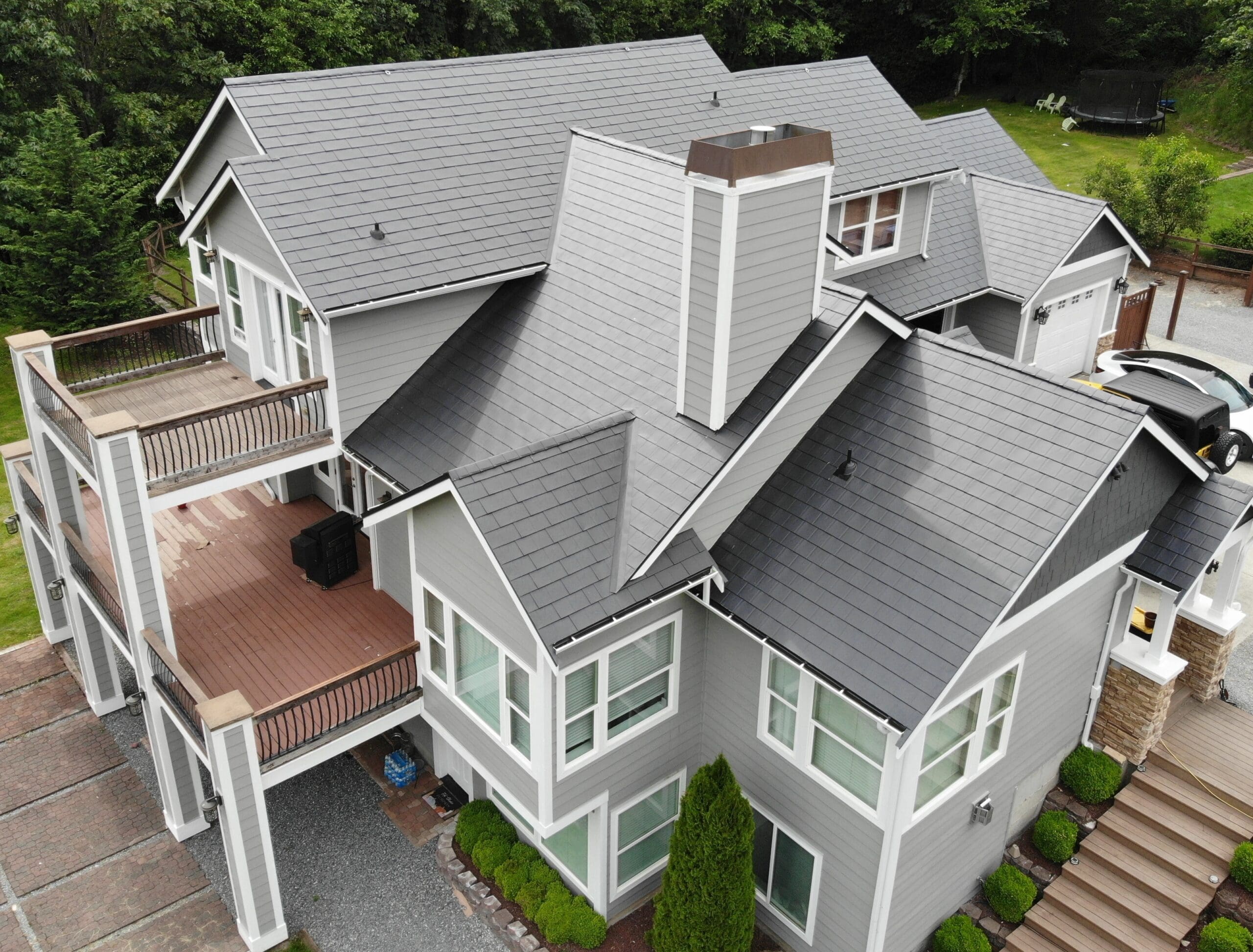 Black Slate Aluminum Shingle installed on a beautiful gray house in Buckley, WA. Picture taken from above to help illustrate metal roof colors and cost of metal roof and What Is the Difference Between Metal Roof and Shingles.