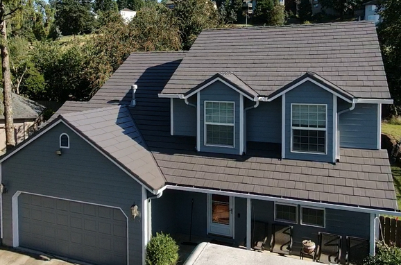 New Charcoal metal shingles on a two story home to help illustrate metal roof vs asphalt shingles
